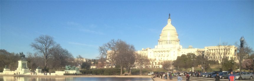 U.S. Capitol building under clear blue sky.