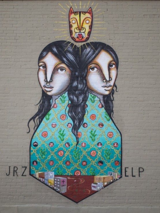 Two-headed figure mural with patterned cloak.